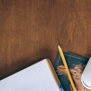 World map with notebook and computer mouse | wooden table top view | global business workspace